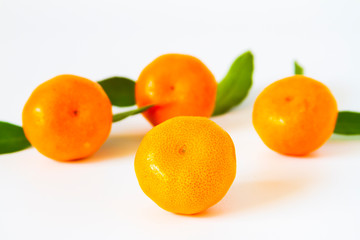 Tangerine Orange or clementine with green leaf isolated on white background