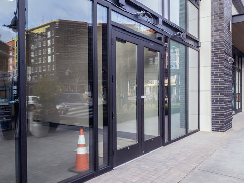 Front Doors For A Business Still Under Construction And Locked With A Padlock Key In A Shopping Complex