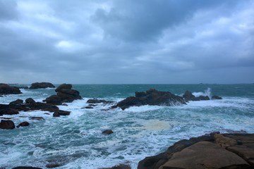 Beautiful view of the pink granite coast during storm in Brittany. France