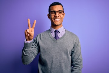 Handsome african american businessman wearing glasses and tie over purple background smiling with...