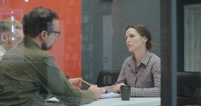 Business owners interviewing female job candidate in office