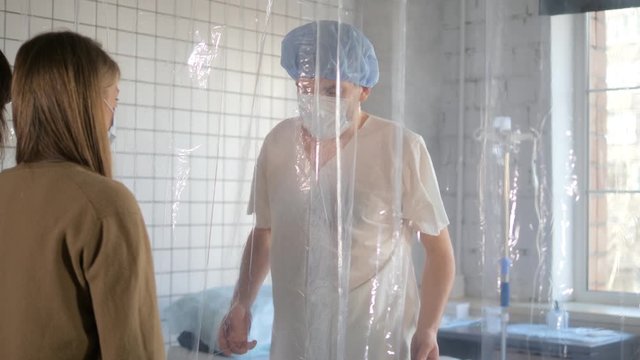 Isolated patient dancing in front of his visiting friends in a hospital.