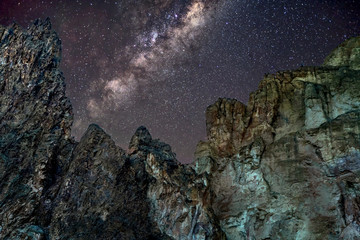 The towering cliffs under a star filled night sky at Smith Rock State Park near Bend, Oregon, USA...