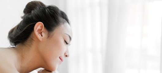Smiling of young beautiful pretty asian woman clean fresh healthy white skin spa treatment relaxing lying on towel in massaging and spa salon