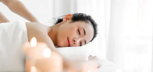 Fotobehang Smiling of young beautiful pretty asian woman clean fresh healthy white skin spa treatment relaxing lying on towel in massaging and spa salon © Art_Photo