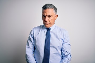 Middle age handsome grey-haired business man wearing elegant shirt and tie skeptic and nervous, frowning upset because of problem. Negative person.