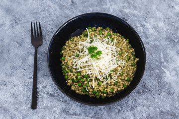 healhty plant-based food, pesto pea buckwheat with vegan cheese topping