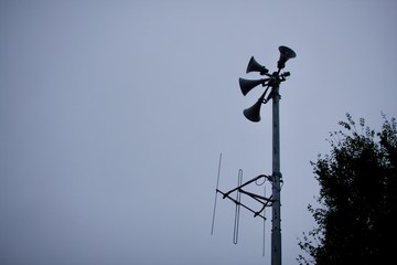 Disaster speaker and antenna on cloudy day