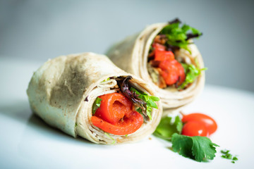 A fresh tasty California turkey wrap displayed on white platter