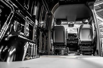 The cargo compartment of a compact minivan with open doors is ready for loading commercial goods for delivery.