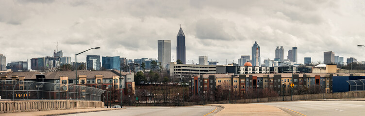 Downtown Atlanta Skyline showing several prominent buildings, apartments and hotels under a cloudy sky.