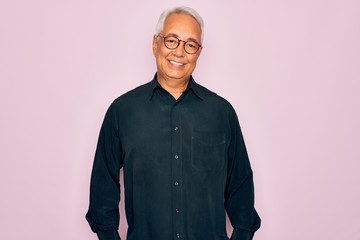 Middle age senior grey-haired handsome man wearing glasses and elegant shirt with a happy and cool smile on face. Lucky person.