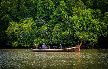 Small local fishing boats in southern Thailand go out to fish in the morning.