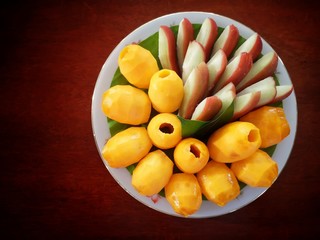 Boueaburmanica Griff. Java apple. Thai fruit is on a white plate. Placed on the wooden floor.