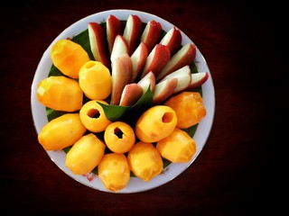 Boueaburmanica Griff. Java apple. Thai fruit is on a white plate. Placed on the wooden floor.