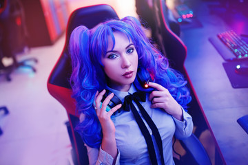 Young woman streamer anime cosplay professional gamer playing video online games computer