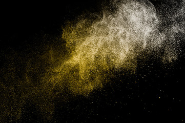 Fototapeta na wymiar golden powder splash and brush for makeup artist or graphic design in black background