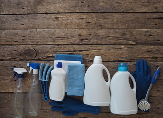 The concept of general cleaning with natural detergents. Plastic bottles of detergents on a wooden background. Cleaning and washing of the day.