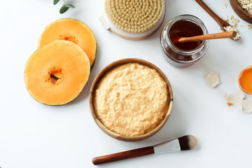 Body care natural cosmetic products top view. Body mask with pumpkin, oatmeal, honey, egg and yogurt to moisturize. Self care concept