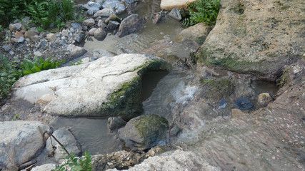 Water running slowly down rural river bed