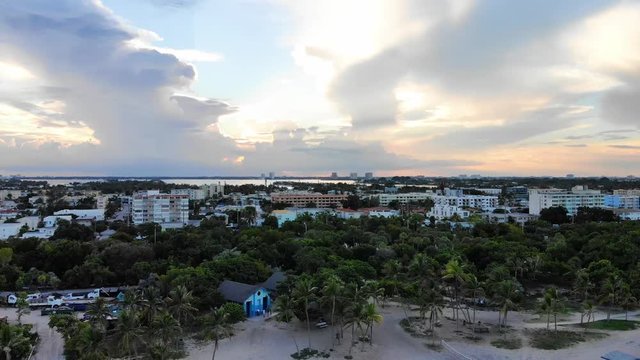 Slow aerial pan to the left showing ocean, construction and condos in Miami Beach.