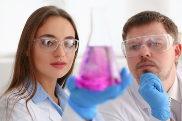 Technician hold in arms in protective gloves sample bottle with poison fluid portrait. Medical...