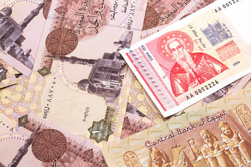 A macro image of a red and white Bulgarian lev bank note with Egyptian one pound bank notes