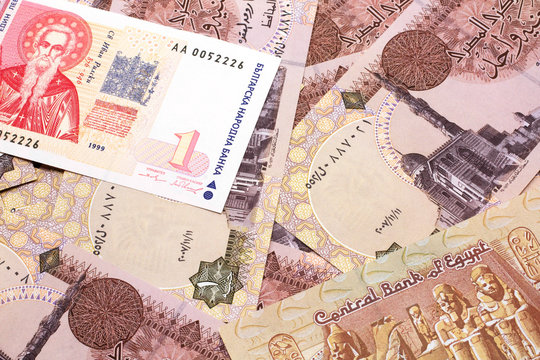 A macro image of a red and white Bulgarian lev bank note with Egyptian one pound bank notes