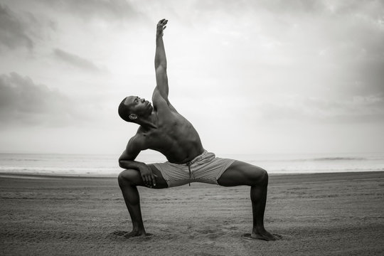 dance choreographer and dancer doing ballet beach workout - young attractive and athletic black African American man dancing outdoors doing beautiful performance