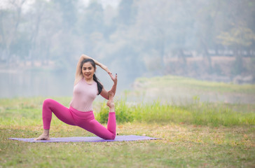 Obraz premium Woman yoga-Beautiful position ,relax and happy in nature.
