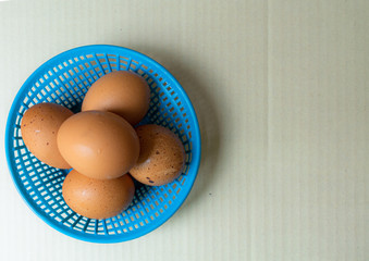 Spotted reddish yellow eggs in blue basket