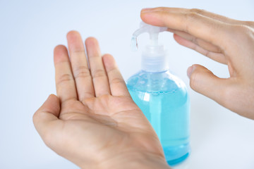 Man washing hands with sanitizer gel bottle or soap for coronavirus prevention, hygiene to stop spreading covid-19 (select focus)