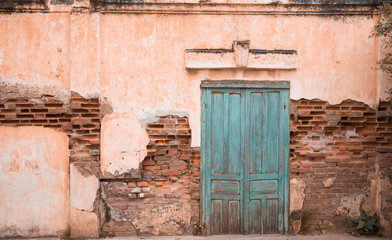 Fototapeta na wymiar The blue door on the old building wall In Savannakhet, Laos