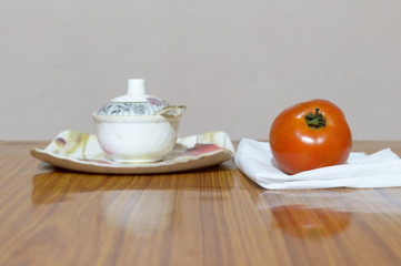 Tomato and Saucers on wooden dining table. Tomato sauce (Neapolitan sauce, salsa roja in Spanish, or salsa di pomodoro in Italian)