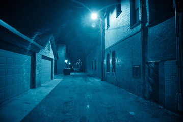 Dark and eerie urban city alley at night