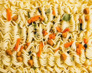 Raw instant noodles on the rustic background. Selective focus. Shallow depth of field.