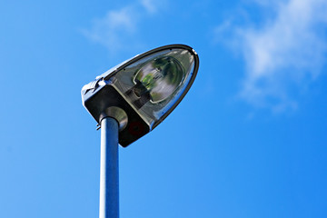 modern street lamp from below and blue summer sky
