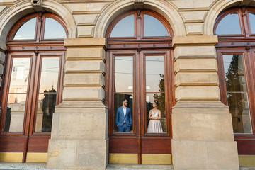 Fototapeta na wymiar Loving couple hid behind glass doors