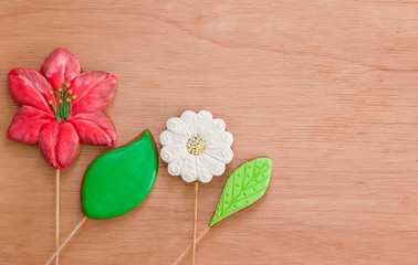 Gingerbread, cookies in the form of a leaf flower, chocolate number 1. Theme back to school, blank for a postcard. Beige wooden background with a copy of the space