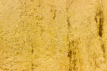 yellow texture color of a stone wall covered with cracks, a place for designer's ideas and advertising