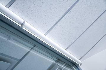 White Roller blind for office room privacy. Modern meeting room eye screen. Concept image for...
