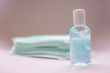 masks and hand sanitizer gel for hand hygiene spread protection Coronavirus, Covid 19 on white background. soft focus.