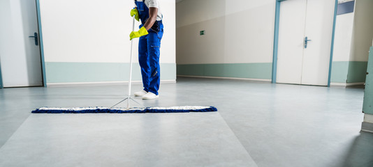 Male Janitor Cleaning Floor In Office - obrazy, fototapety, plakaty