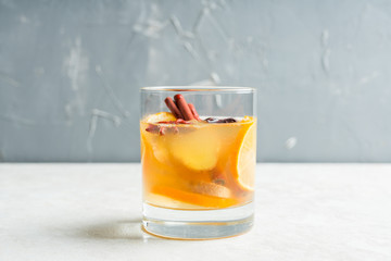 Healthy hot beverage with lemon, ginger and spices for protection in flu season. Selective focus. Shallow depth of field.