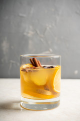 Healthy hot beverage with lemon, ginger and spices for protection in flu season. Selective focus. Shallow depth of field.