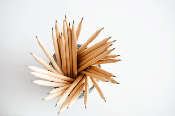 lead pencil in office cup with white background, top view