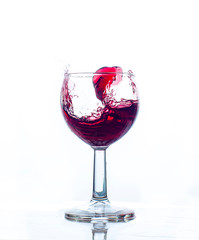 glass splash red wine with white background celebration