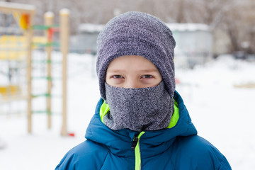 The danger of coronavirus. A boy on a walk walks in a medical mask on his face