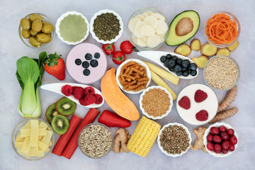 Super food to ease irritable bowel syndrome. Health foods high in antioxidants, protein, lycopenes, dietary fiber, vitamins, minerals, omega 3, smart carbs & anthocyanins. Flat lay.