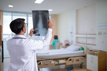 Doctor checking chest x-ray film